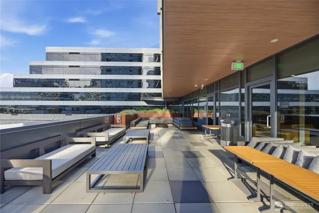 a view of a balcony with chairs and wooden fence