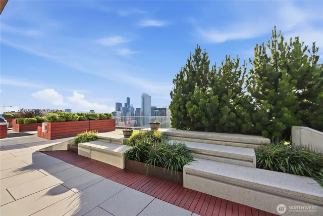 a swimming pool with outdoor seating and city view