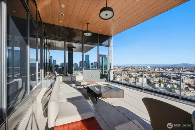 a kitchen with stainless steel appliances kitchen island granite countertop a table chairs in it and wooden floor