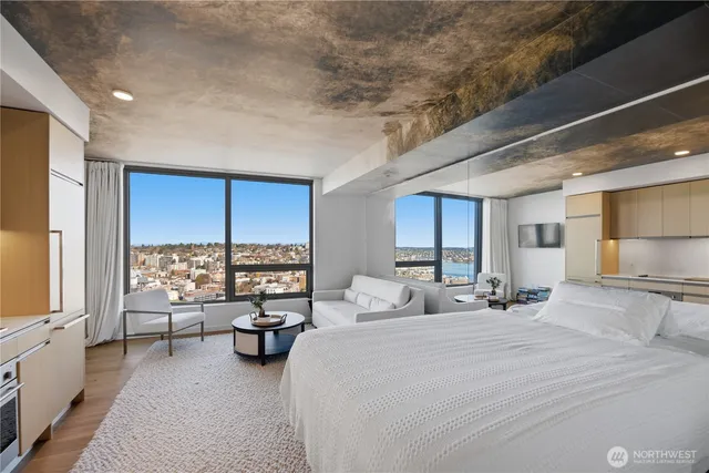 a large bedroom with furniture large window and a table