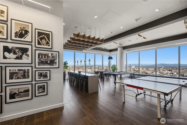 a room with furniture pool table and flat screen tv