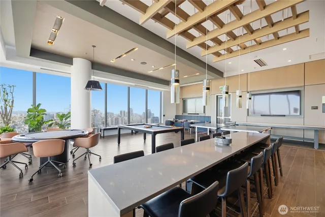 a living room with furniture a flat screen tv and kitchen view