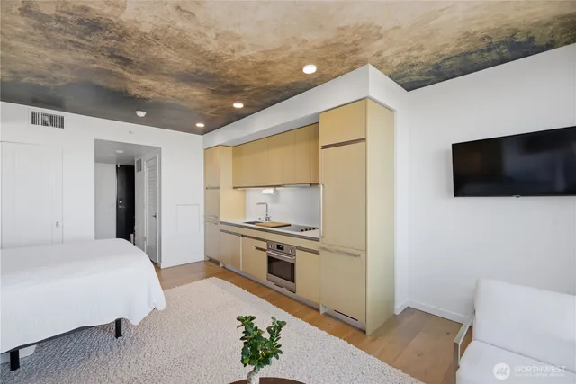 a bedroom with a bed and a flat screen tv