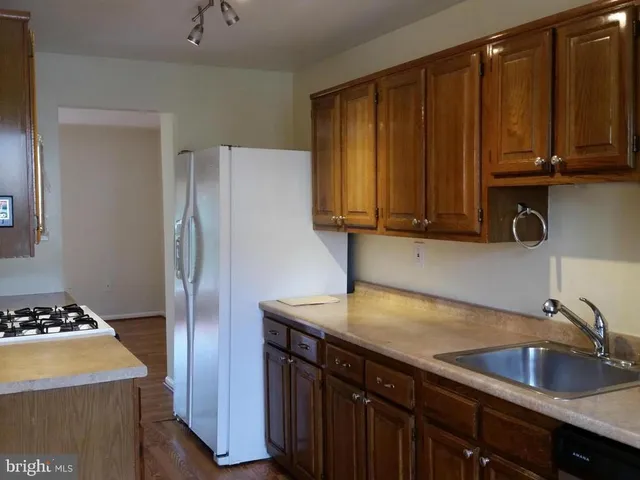 a kitchen with appliances a sink and cabinets