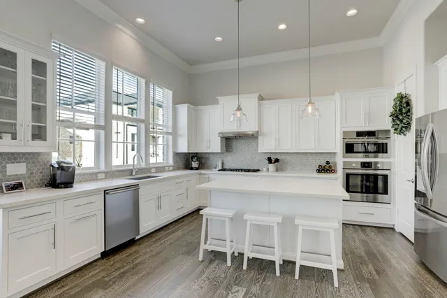 a large kitchen with a table and chairs in it