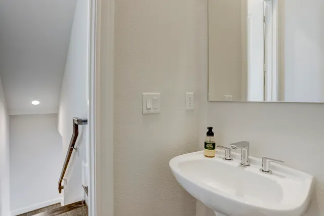 a bathroom with a sink and mirror