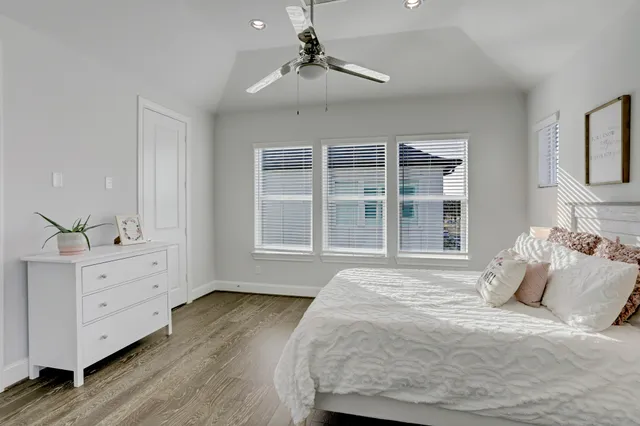 a bedroom with a large bed and a dresser