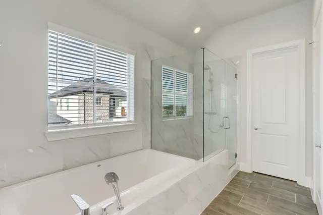 a bathroom with a bathtub and a shower