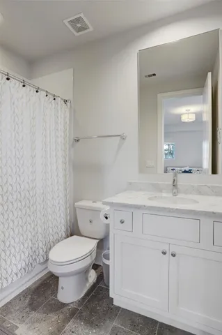 a bathroom with a toilet a sink and a mirror