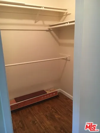 a view of an empty room and wooden floor