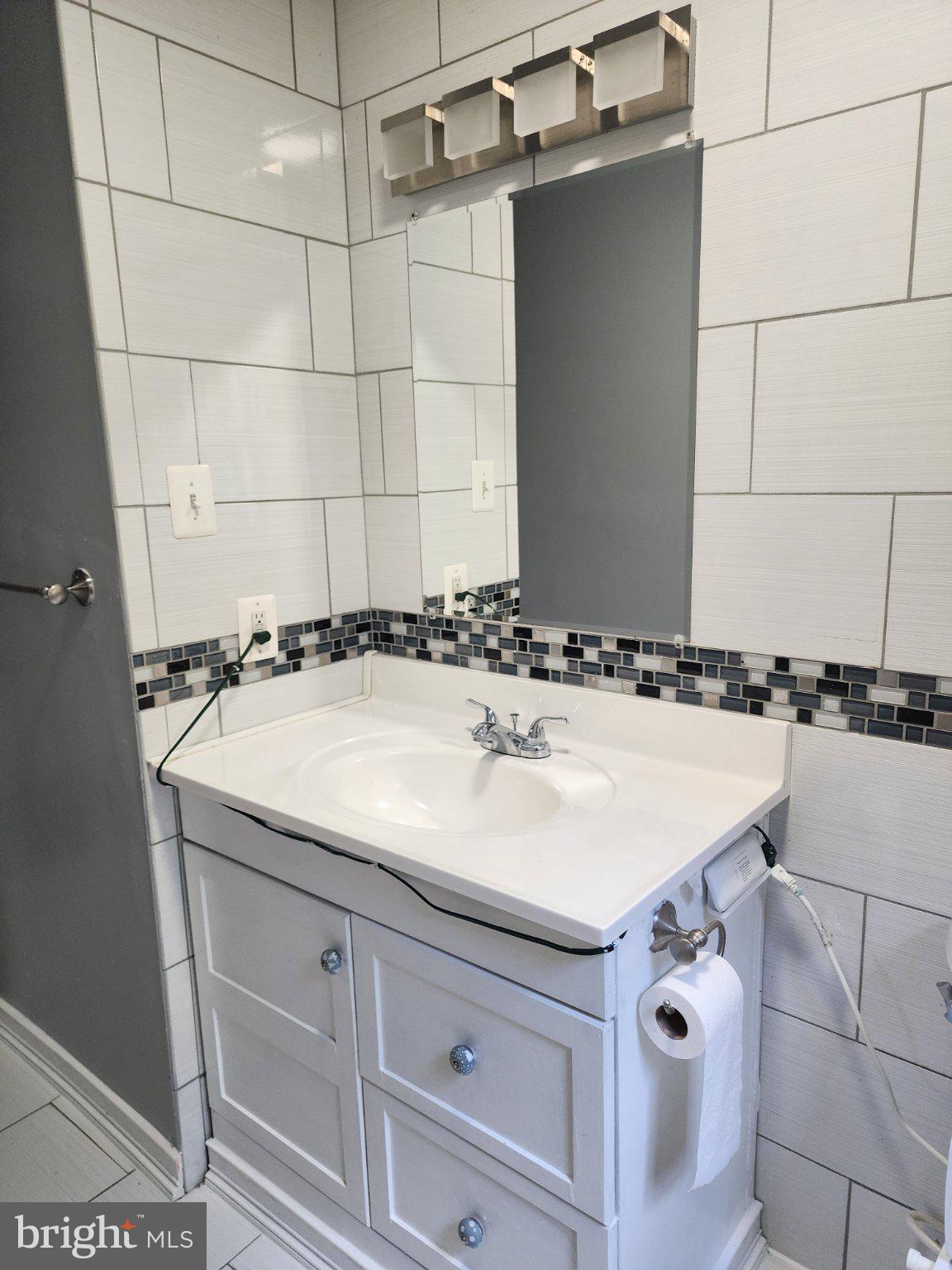 13 Main Street Huntingtown, MD 20639 - Photo 19 of 32 Sleek modern bathroom with stylish tiles.