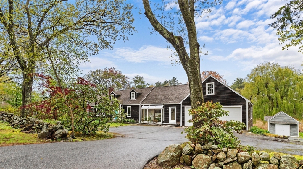 128 Argilla Road Ipswich, MA 01938 - Photo 4 of 25 front view of a house with a trees