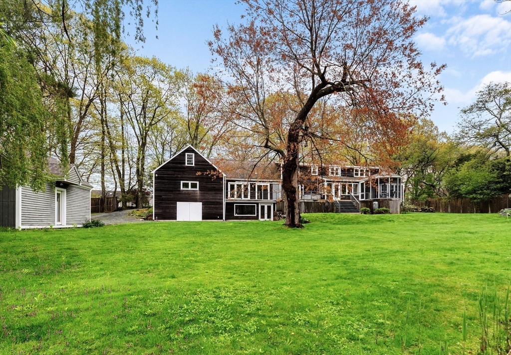 128 Argilla Road Ipswich, MA 01938 - Photo 5 of 25 a view of a house next to a big yard and large trees
