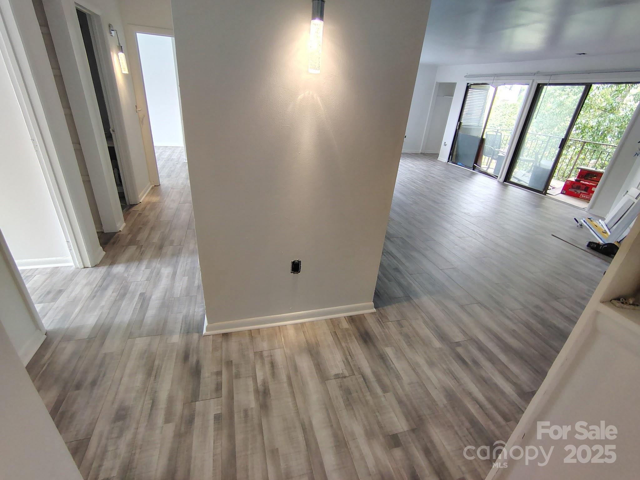 4821 Spring Lake Drive, Unit C Charlotte, NC 28212 - Photo 2 of 5 wooden floor in an empty room with a window