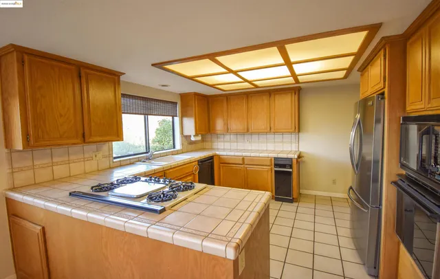 a kitchen with a sink cabinets and stainless steel appliances
