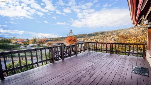 a view of wooden balcony with furniture