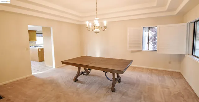 a view of a room with a table and chairs