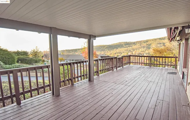 a view of a balcony with floor to ceiling windows with wooden floor