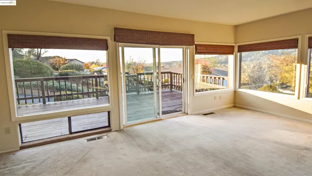 an empty room with large windows