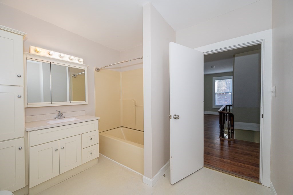 7 Ramsdell Street Warren, MA 01083 - Photo 18 of 34 a spacious bathroom with a double vanity sink a mirror and a bathtub