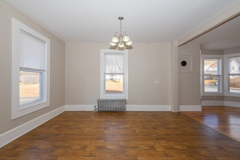 7 Ramsdell Street Warren, MA 01083 - Photo 5 of 34 an empty room with wooden floor cabinet and windows
