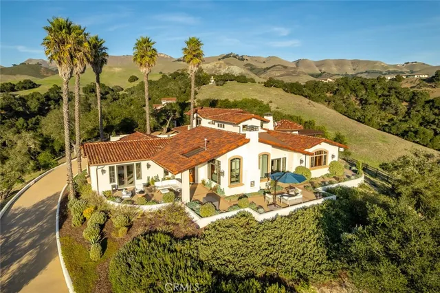 a view of a patio with a table chairs and a barbeque