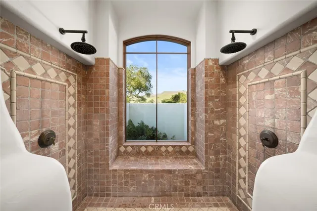 a view of a patio with lawn chairs plants and large tree