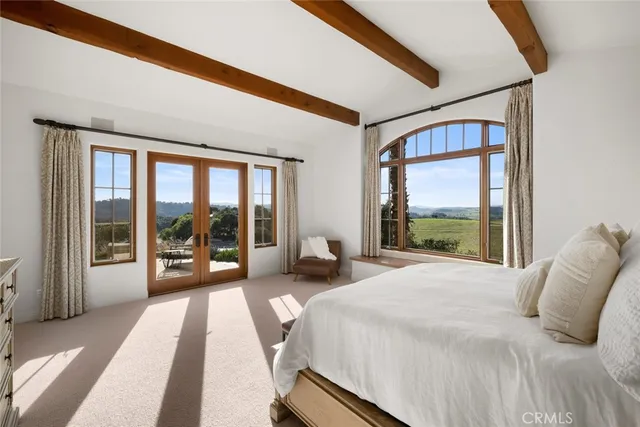 an aerial view of a house with a garden and outdoor seating