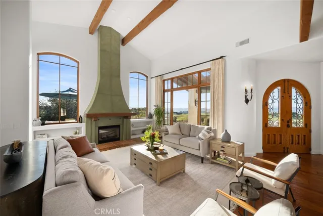 a dining room with wooden floor a chandelier a glass table and chairs