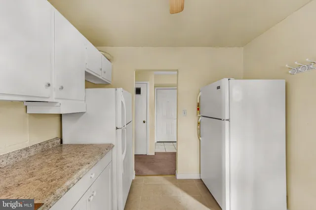 a kitchen with a refrigerator and a sink