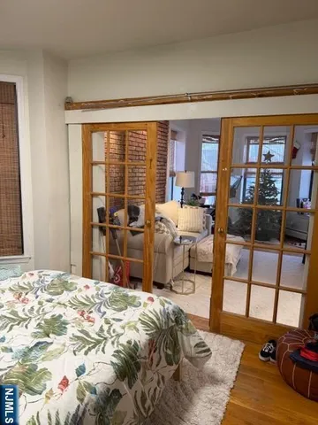 a bed sitting in a bedroom next to a window