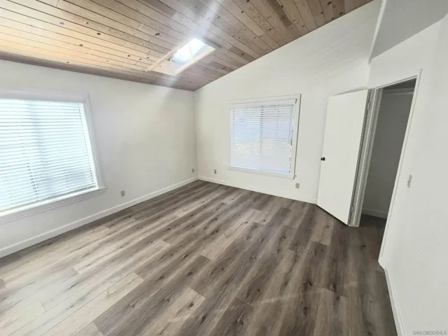 a view of room with window and hardwood floor
