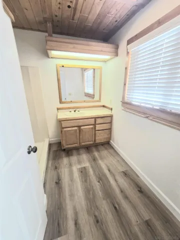 a view of bathroom with bathtub and window