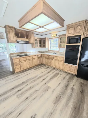 a kitchen with stainless steel appliances granite countertop a stove and a sink