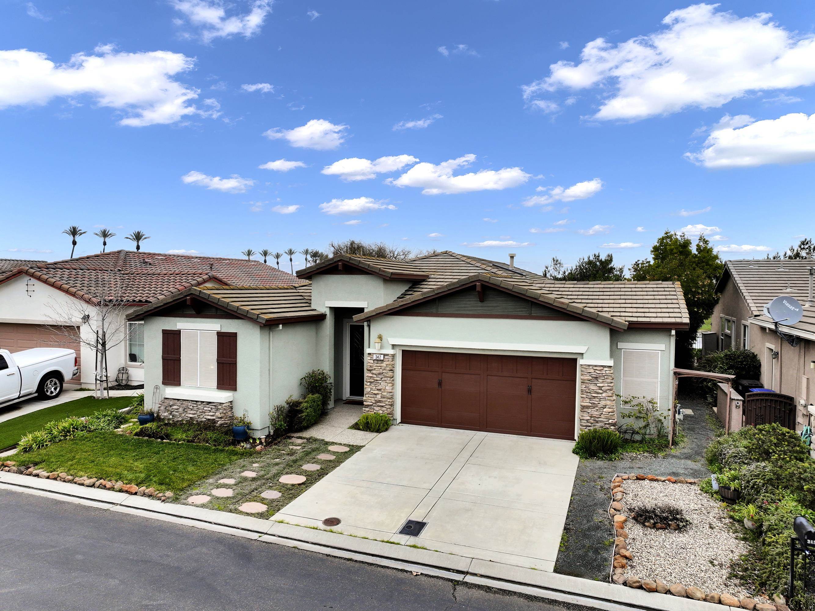 342 Desert Forest Court Rio Vista, CA 94571 - Photo 15 of 40 View of front of home featuring a tile roof, stone siding, stucco siding, and concrete driveway