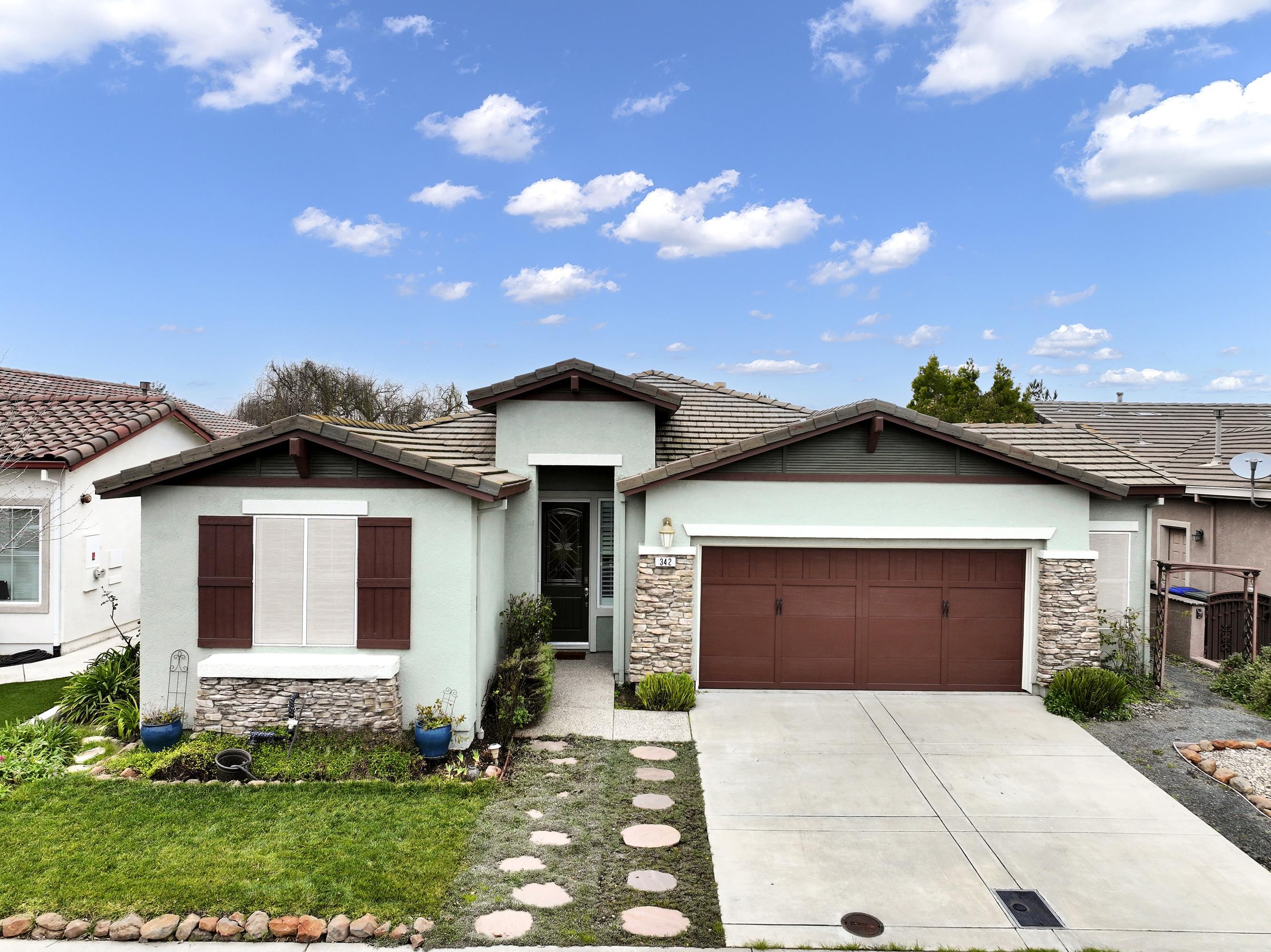 342 Desert Forest Court Rio Vista, CA 94571 - Photo 16 of 40 View of front of property with a tile roof, stone siding, stucco siding, a garage, and driveway