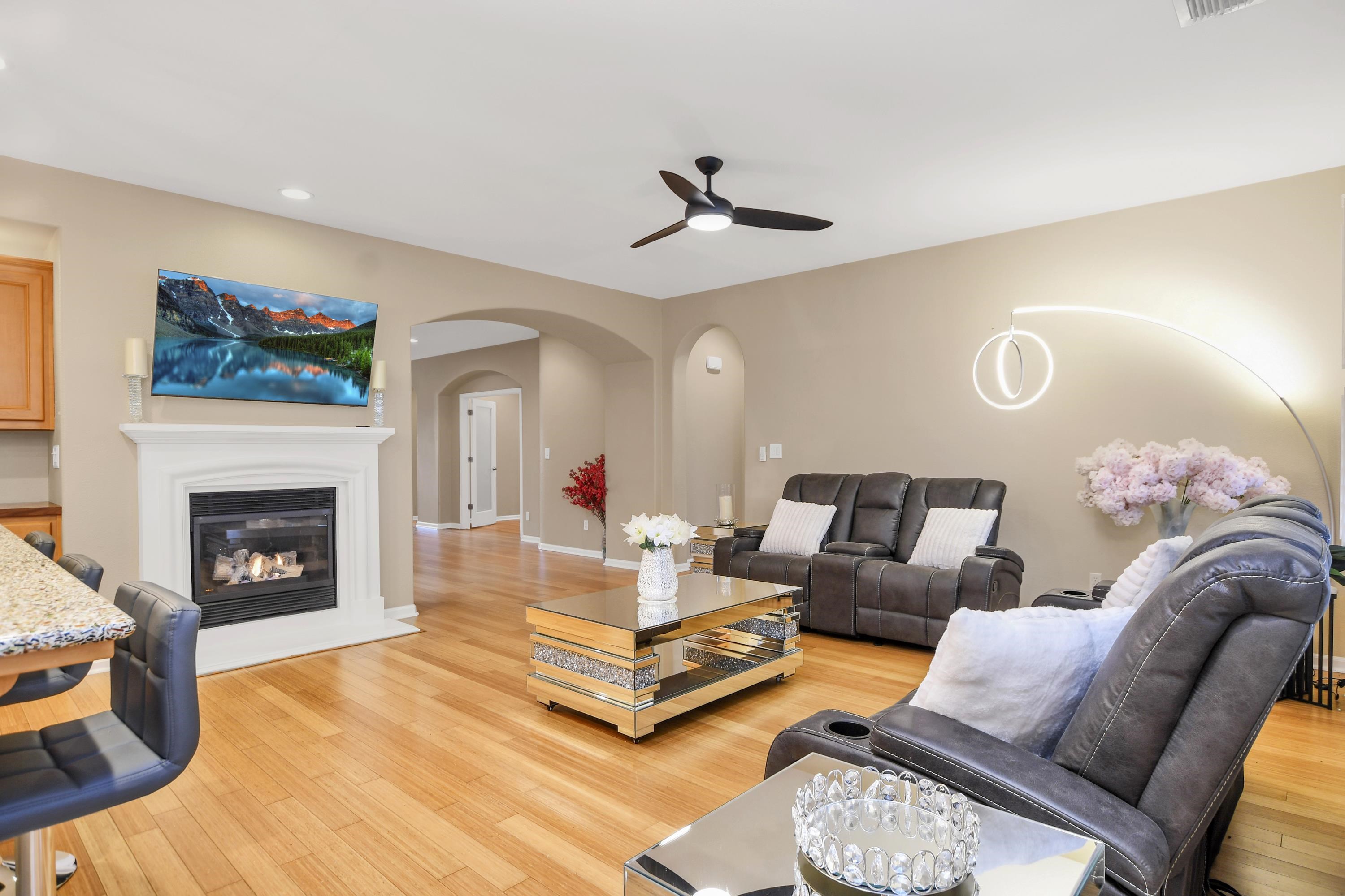 342 Desert Forest Court Rio Vista, CA 94571 - Photo 20 of 40 Living room with a glass covered fireplace, light wood-type flooring, ceiling fan, arched walkways, and recessed lighting