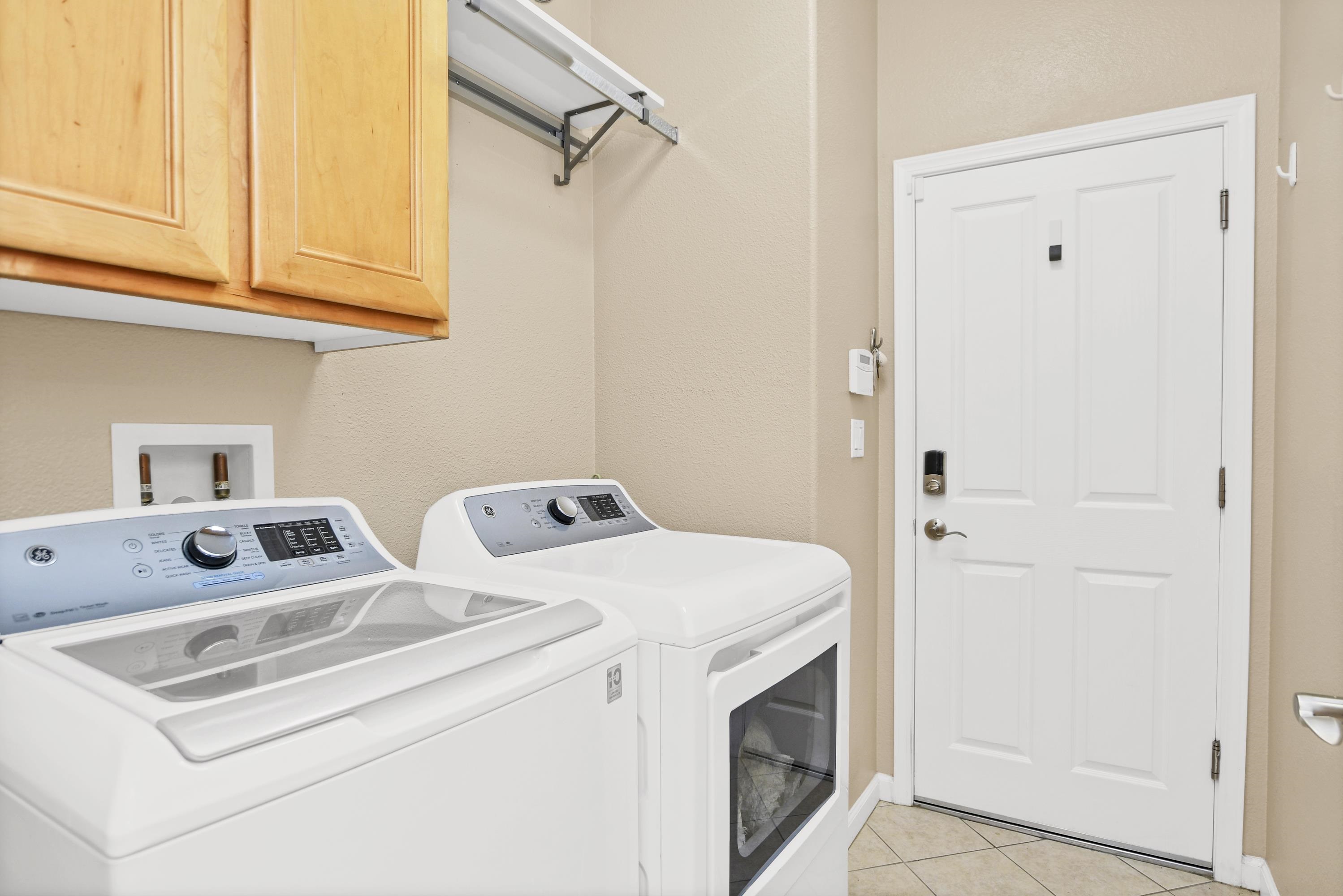 342 Desert Forest Court Rio Vista, CA 94571 - Photo 26 of 40 Washroom with cabinet space, light tile patterned flooring, washing machine and dryer, and a textured wall