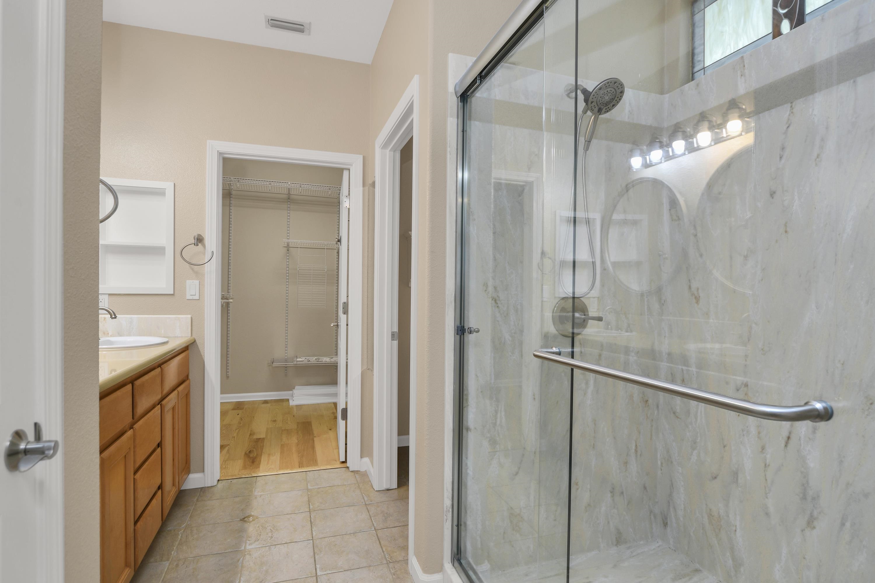 342 Desert Forest Court Rio Vista, CA 94571 - Photo 32 of 40 Full bath featuring vanity, a spacious closet, a marble finish shower, and light tile patterned flooring