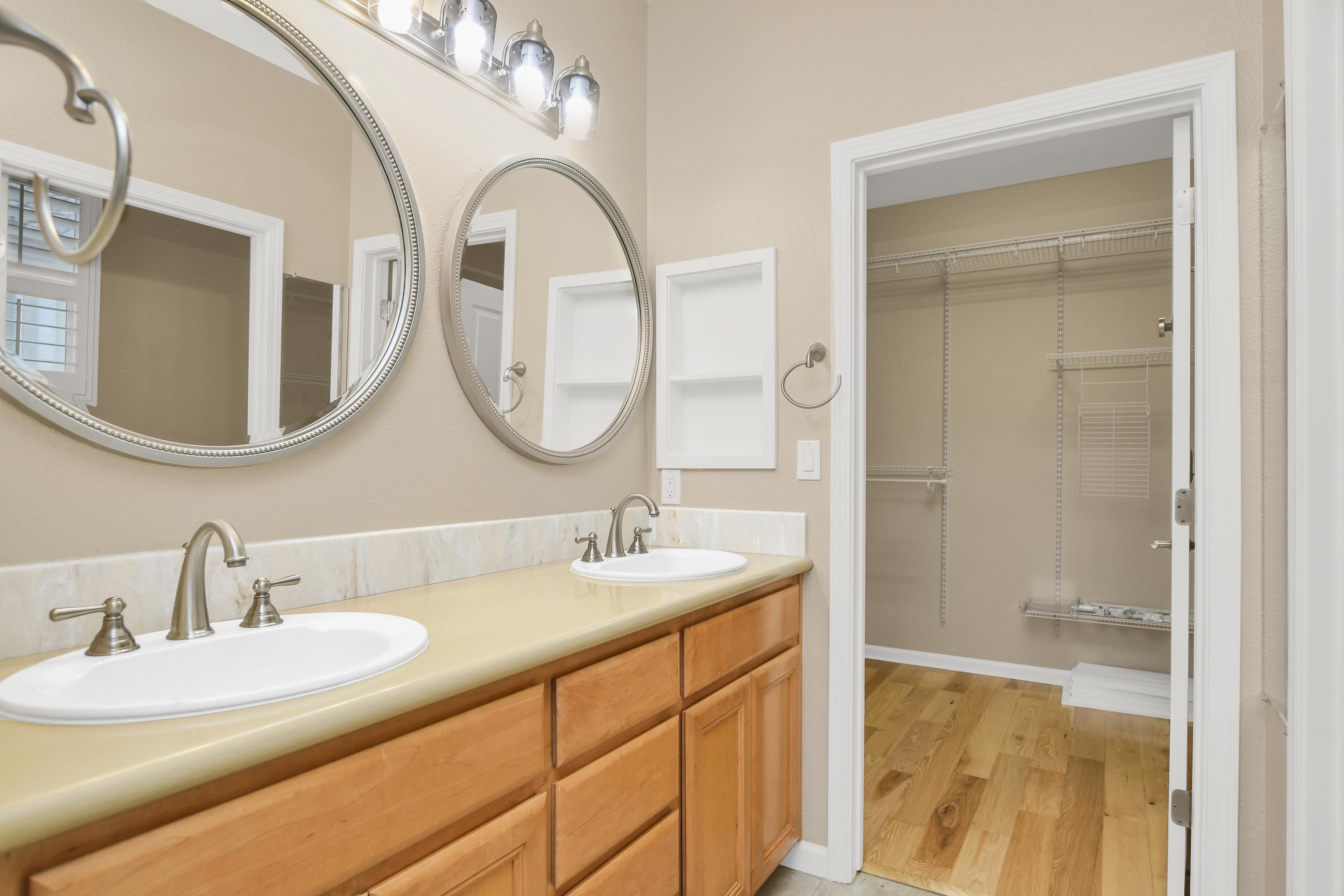 342 Desert Forest Court Rio Vista, CA 94571 - Photo 33 of 40 Bathroom with double vanity, light wood-style floors, and a spacious closet