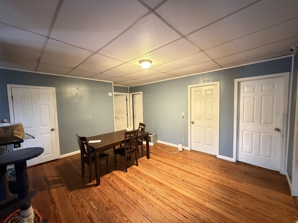 582 Cambridge Street Fall River, MA 02721 - Photo 11 of 19 a bed room with a bed and wooden floor