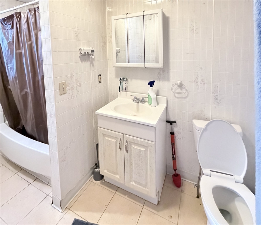 582 Cambridge Street Fall River, MA 02721 - Photo 17 of 19 a bathroom with a sink a toilet and a mirror