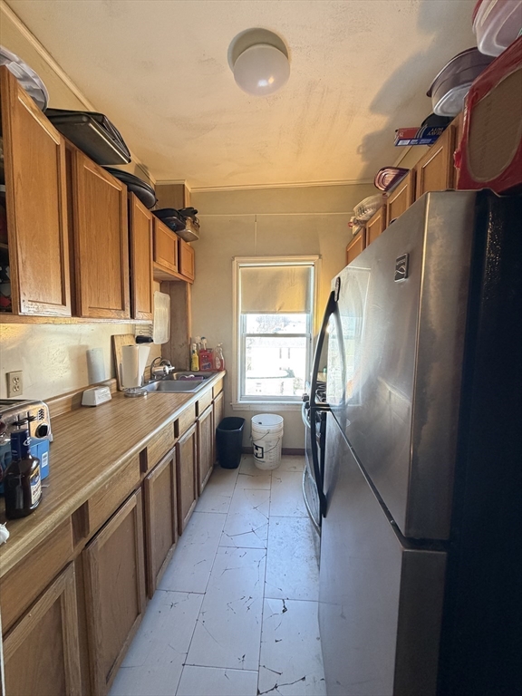 582 Cambridge Street Fall River, MA 02721 - Photo 5 of 19 a kitchen with stainless steel appliances a refrigerator and a sink