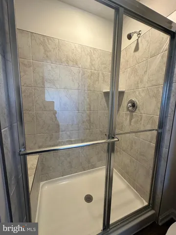 a bathroom with a glass shower door