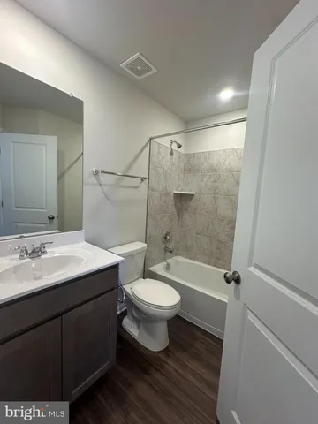 a bathroom with a sink toilet a mirror and shower