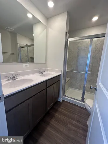 a bathroom with a mirror a sink and shower