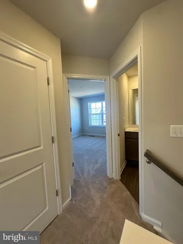 a view of a hallway with wooden shelves