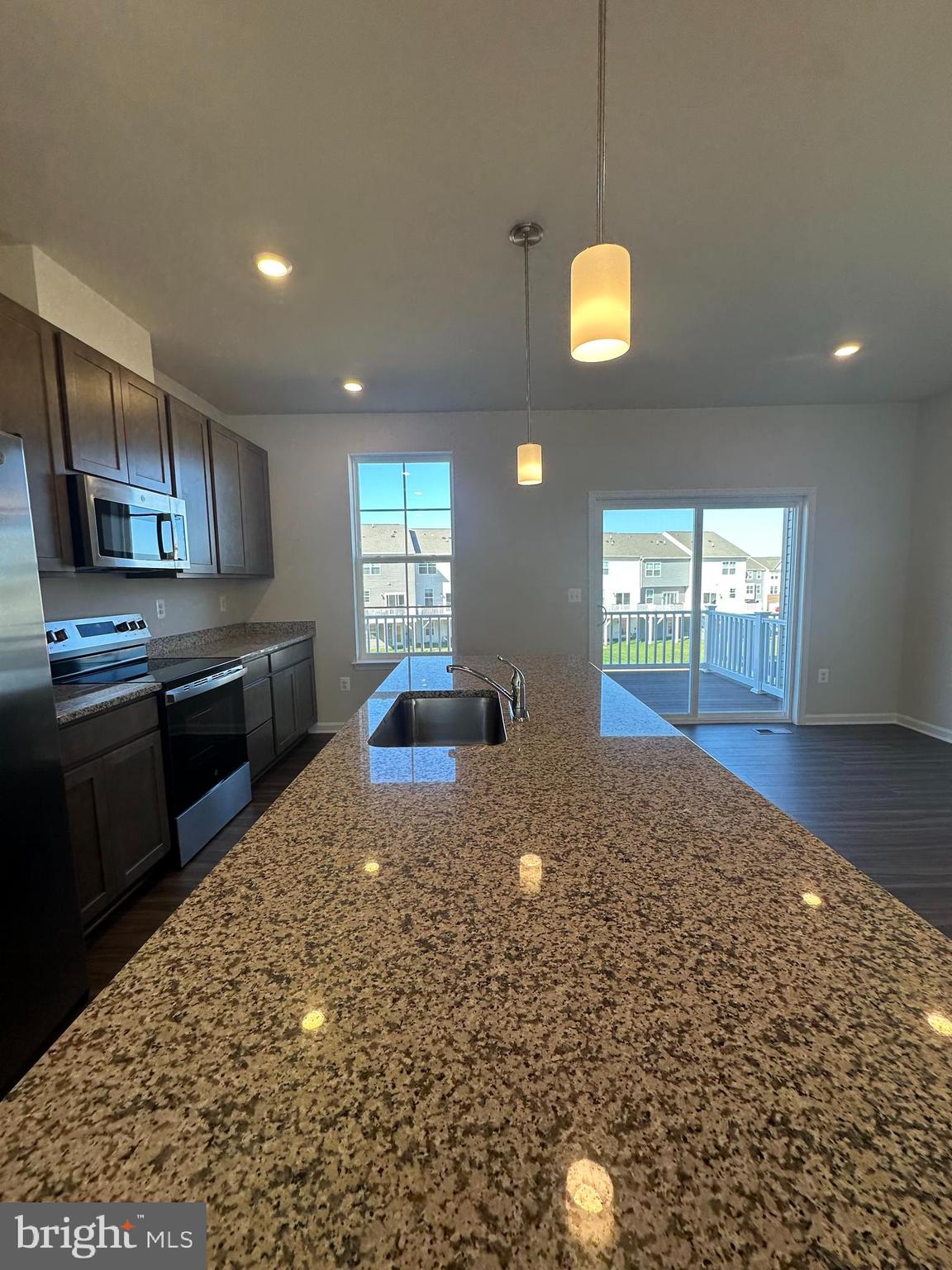 149 Telluride Way Charles Town, WV 25414 - Photo 7 of 39 a kitchen with granite countertop a stove a sink and a granite counter top