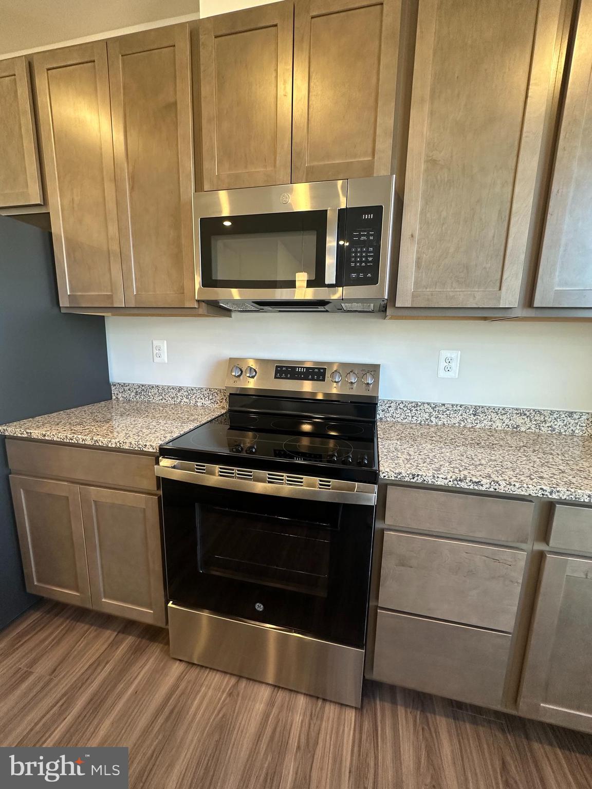 149 Telluride Way Charles Town, WV 25414 - Photo 8 of 39 a kitchen with granite countertop stainless steel appliances and wooden cabinets