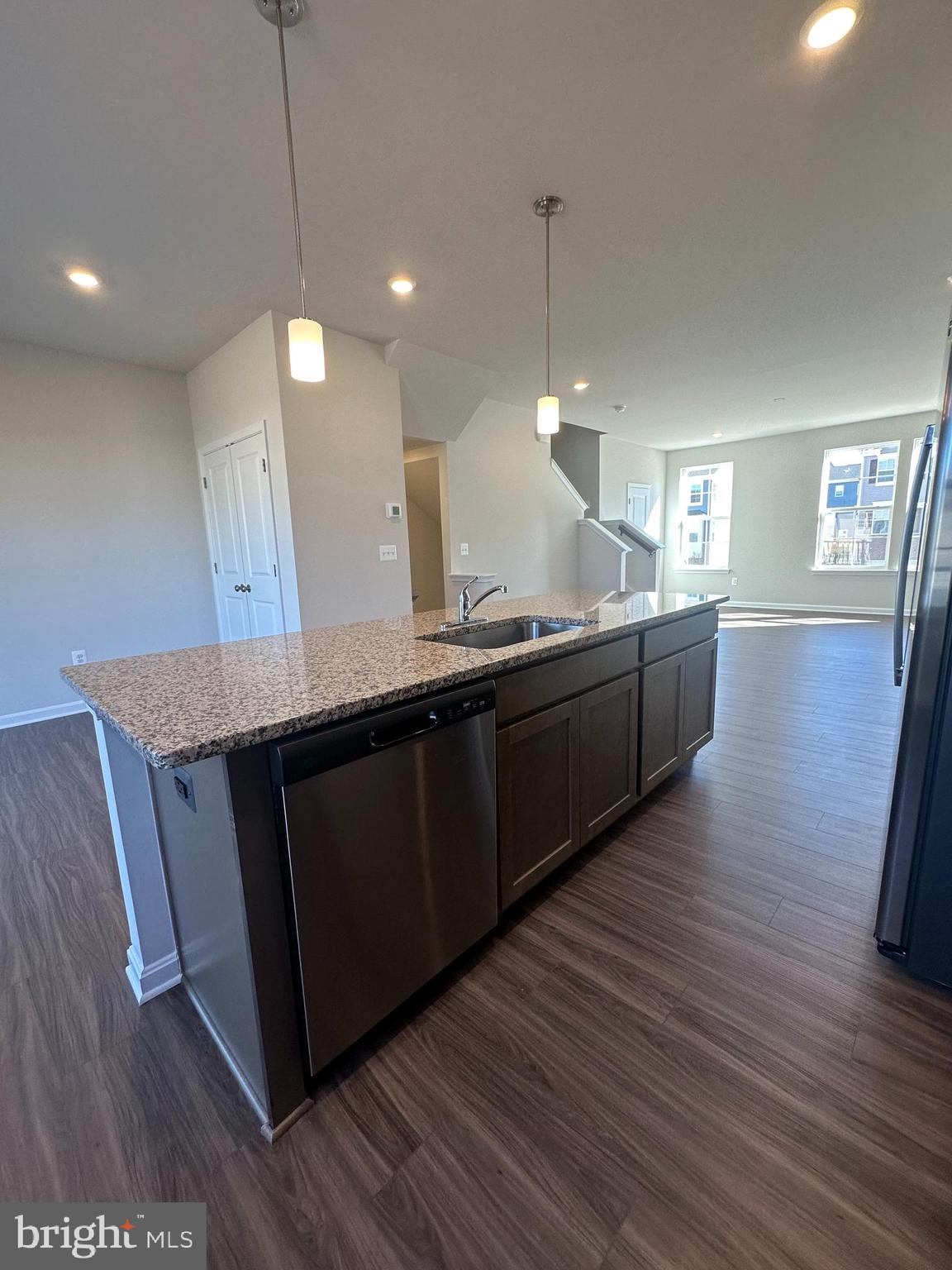 149 Telluride Way Charles Town, WV 25414 - Photo 9 of 39 a kitchen with stainless steel appliances granite countertop a sink a counter space and wooden floor